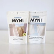 Two packages of MYNI laundry products on a light background