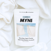 MYNI bleaching agent powder packaging on a white fabric background