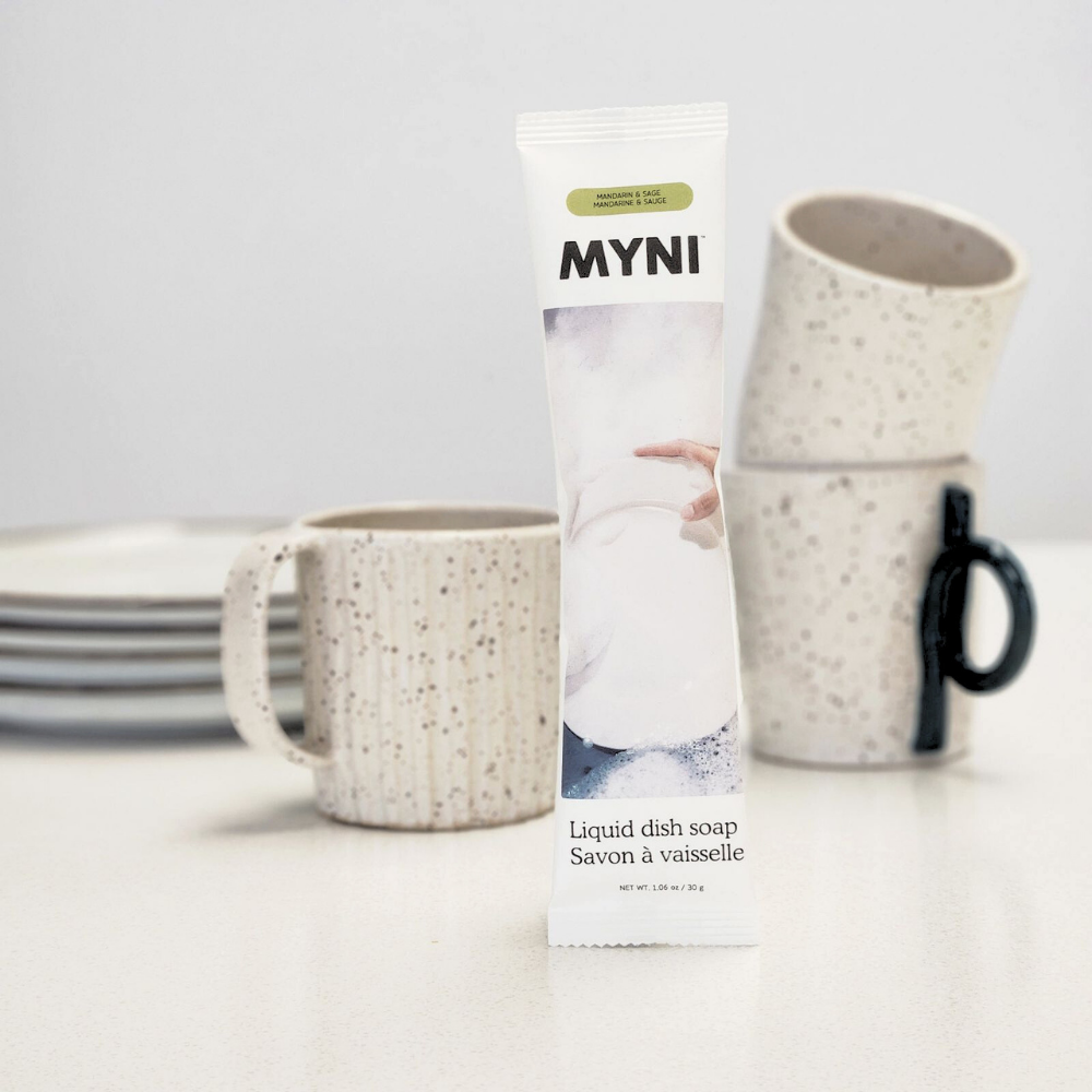 Myni liquid dish soap packaging with speckled mugs on a white surface