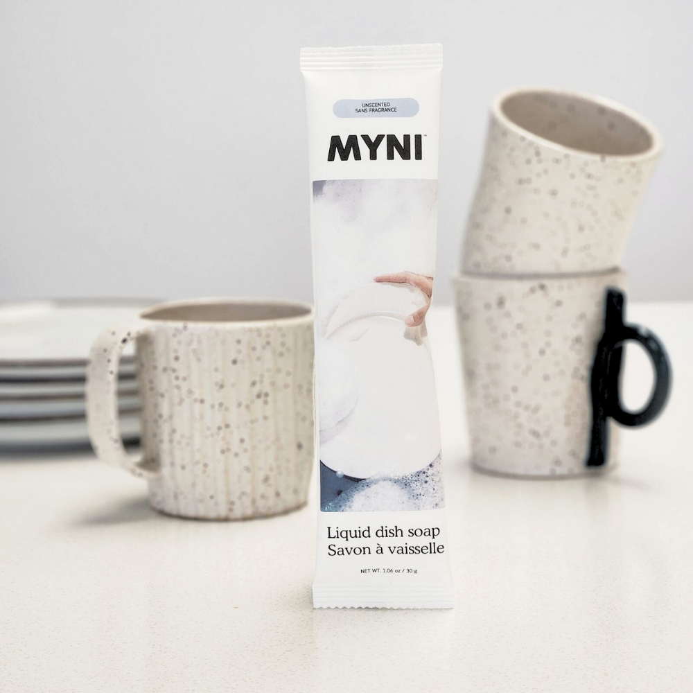MYNI liquid dish soap packaging with speckled mugs on a light surface
