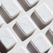Multiple white rectangular objects with a textured surface on a light gray background